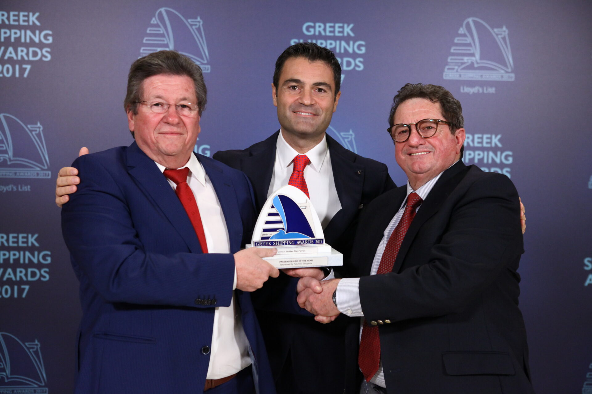 Raffaele Palumbo of sponsor Palumbo Shipyards (centre) presenting the Passenger Line of the Year Award to George Stefanou and Dimitris Stefanou of Golden Star Ferries.