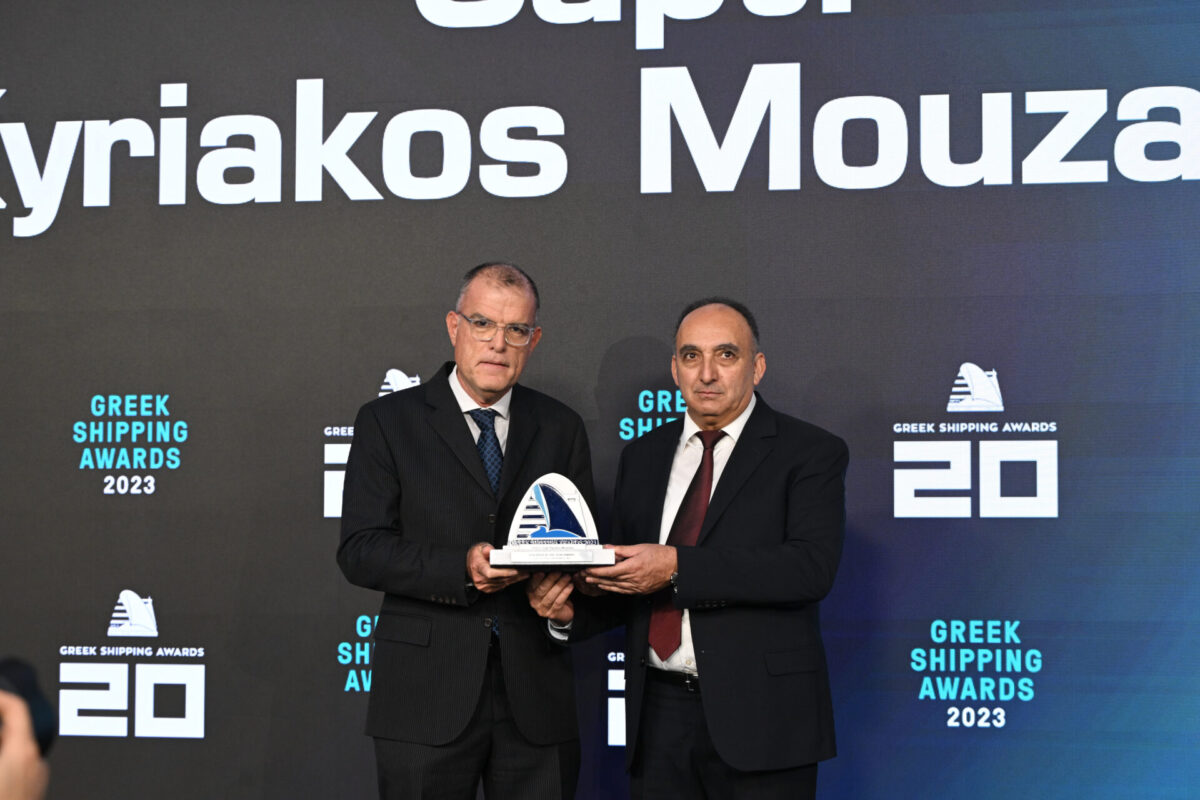 Konstantinos Adamopoulos, chief financial officer of sponsor Safe Bulkers, Inc., presenting the trophy to Captain Kyriakos Mouzakis